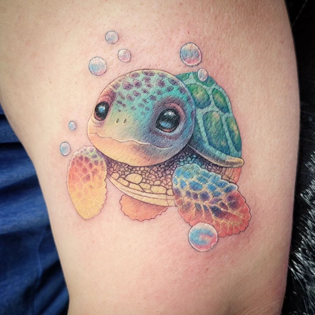 Cute big-eyed baby sea turtle tattoo with bubbles in vivid color