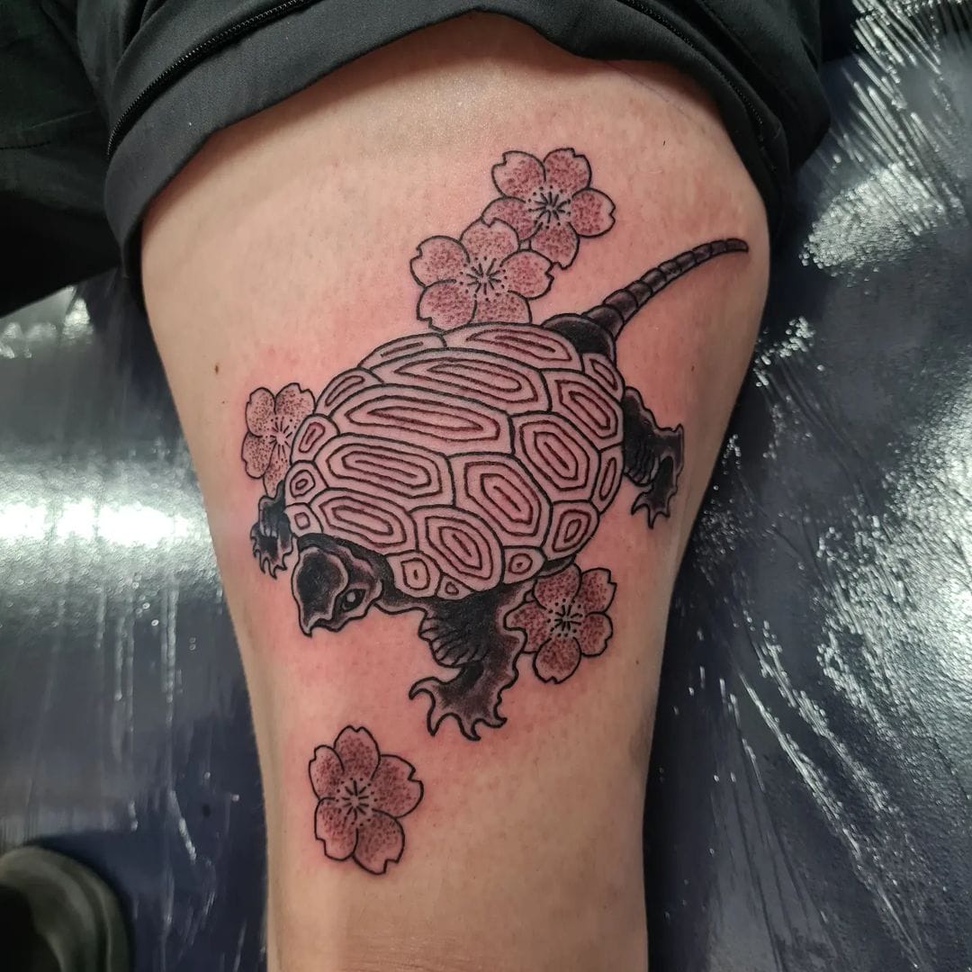Japanese traditional snapping turtle tattoo with cherry blossoms on the thigh