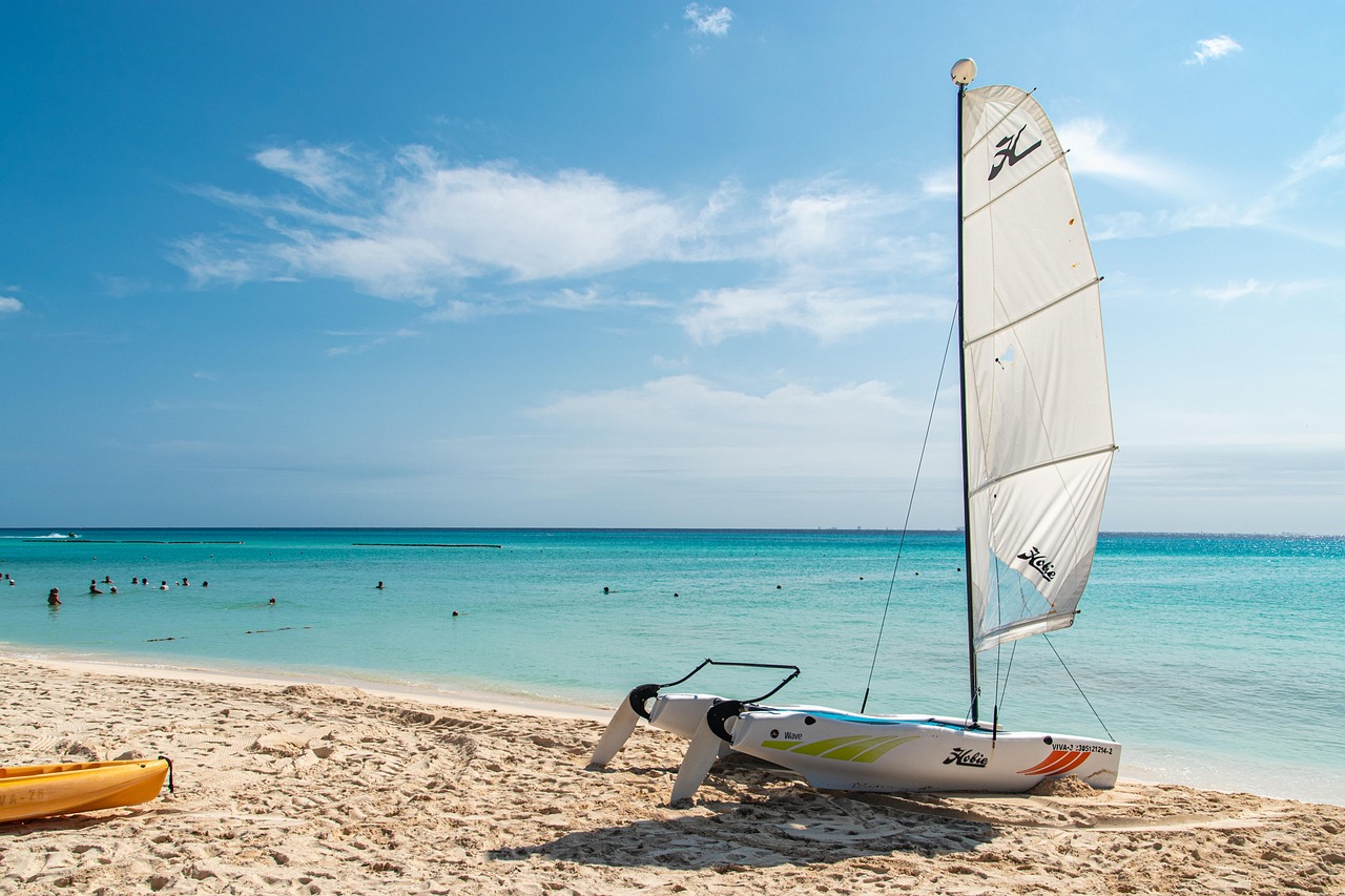 Caribbean tropical beach with turquoise water and a small boat, similar to Grand Cayman's south coast turtle spots