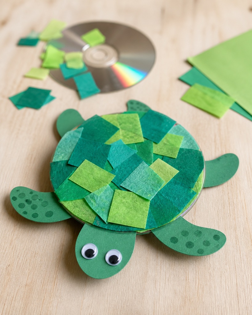Sea turtle craft made from a recycled CD covered in green paper as the shell