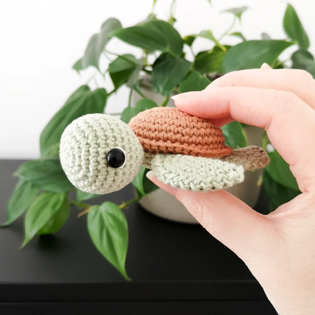 No sew crochet turtle with sage green body and terracotta shell by Stitch by Fay
